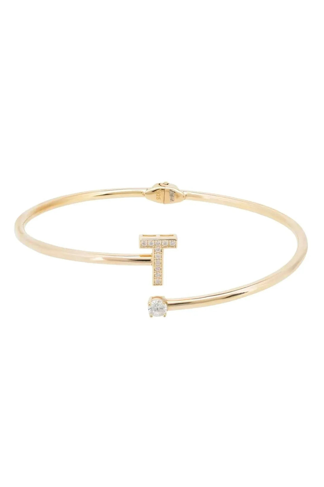 Gold-tone bangle bracelet featuring a vertical T with small crystal accents