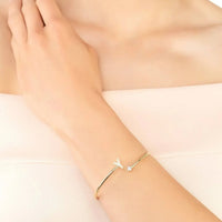 Gold-tone initial Y bangle on wrist with small crystal stones