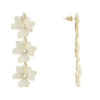 Gold jasmine flower triple drop earrings shown in side view with three stacked blossoms