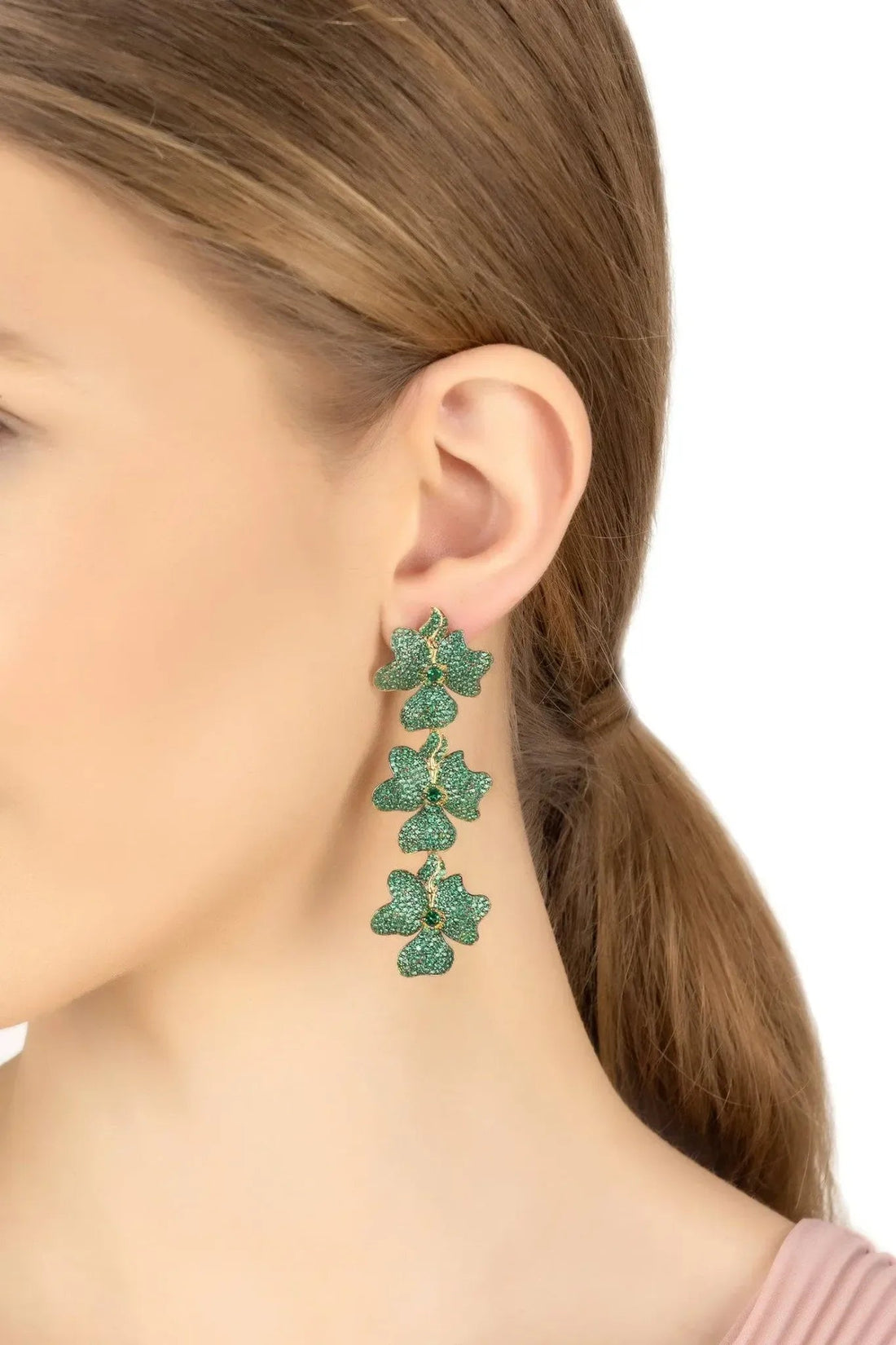 Triple drop green flower earrings on ear, gold-tone hooks