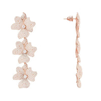 Rose gold triple-drop flower earring with three layered blossoms, side view.
