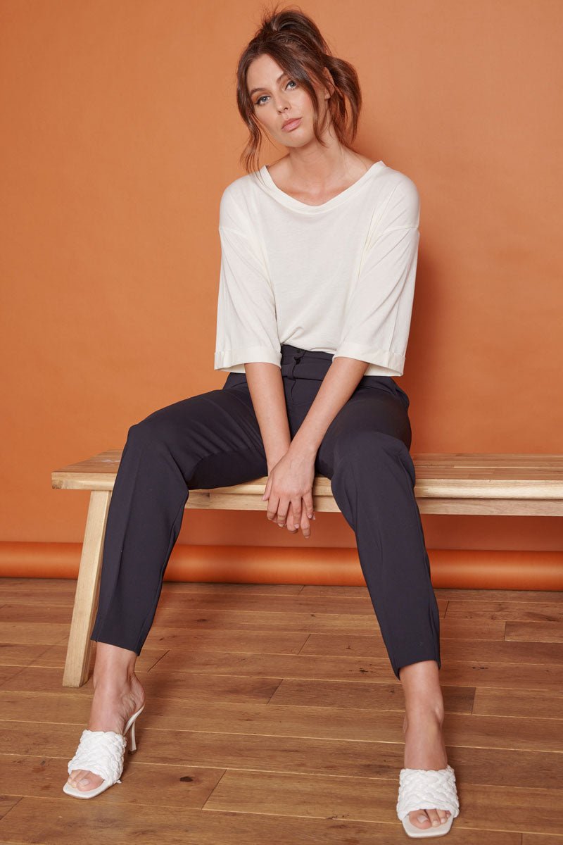 High-waist black tapered trousers with ankle-length fit