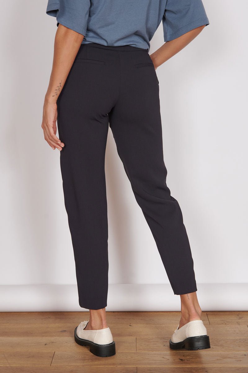 Black high-waist tapered trousers, cropped hem, side view