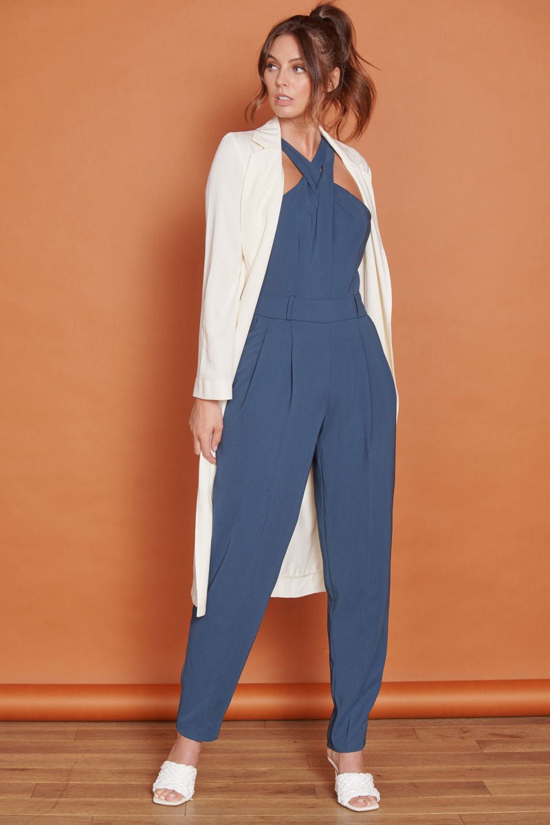 Navy tailored sleeveless jumpsuit with high cross halter neck and tapered ankle legs