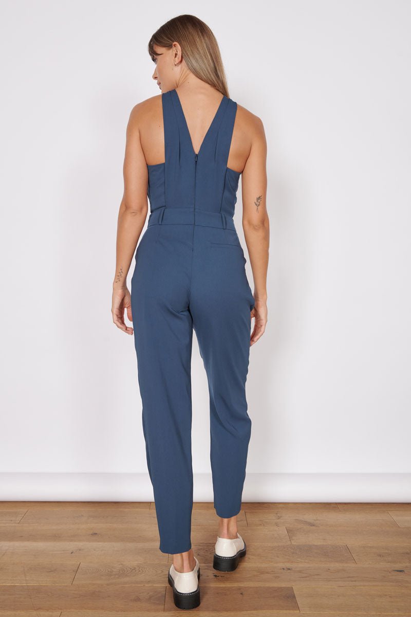 Navy tailored sleeveless jumpsuit with cross-back straps and tapered ankle legs
