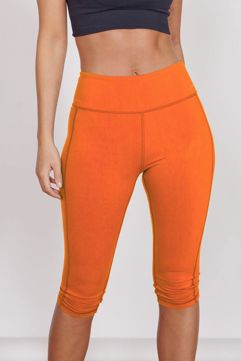 Orange 3/4 sports leggings with hidden zip pocket and contoured waistband