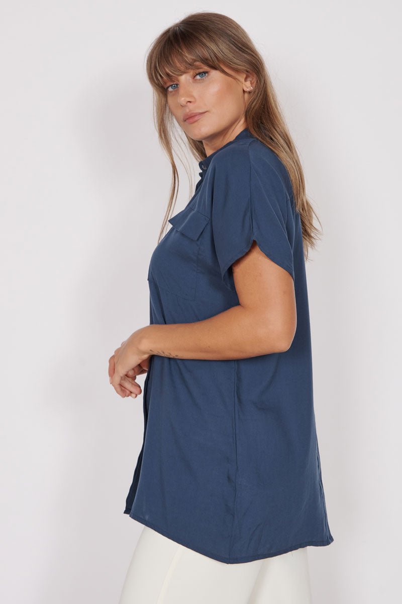 Navy utility shirt with short sleeves and button-front; side view with chest pocket