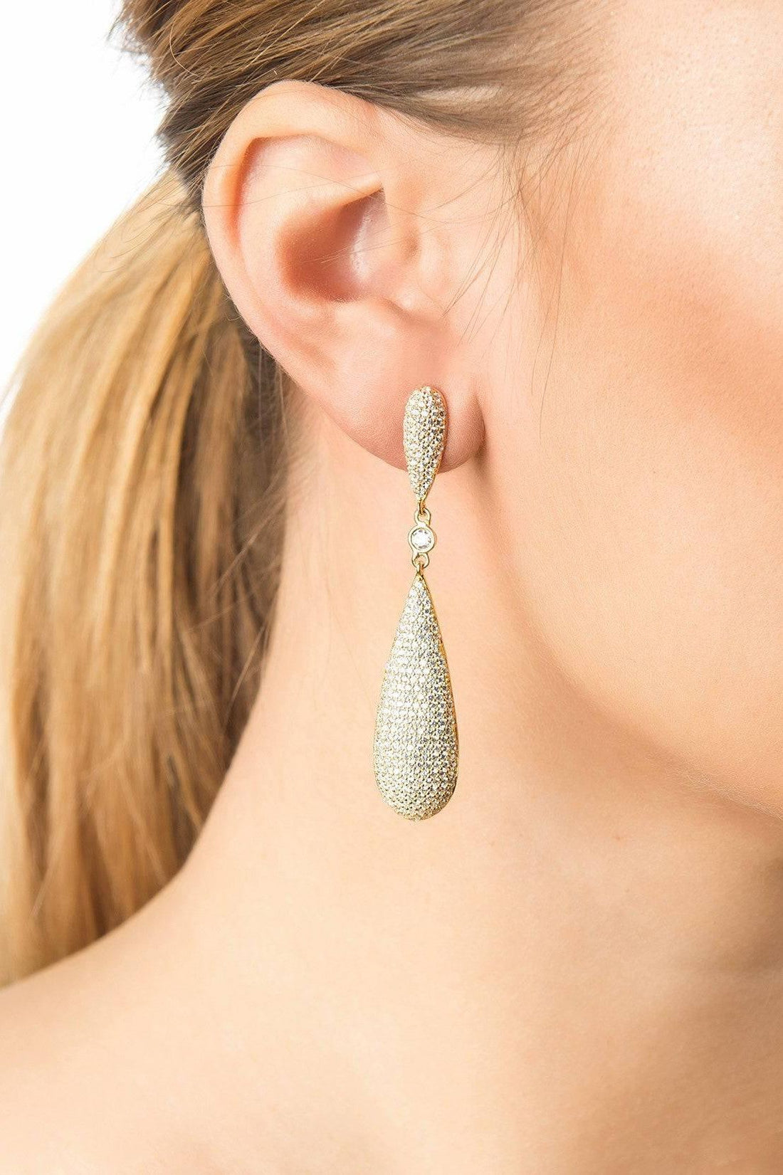 Silver rhinestone teardrop drop earrings worn on ear with dangling oval pieces
