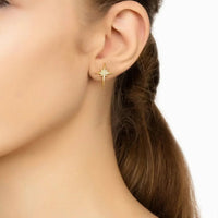Gold star stud earrings with crystal stones and small dangling drop on ear