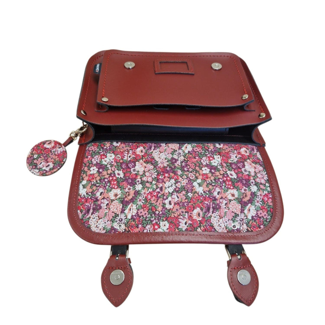 Oxblood leather midi satchel open view, showing floral fabric lining and flap closure