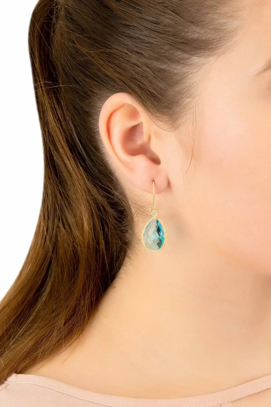 Blue topaz teardrop drop earrings on ear, gold-tone hook