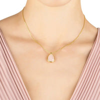 Gold-tone chain necklace with oval rose quartz drop pendant, worn