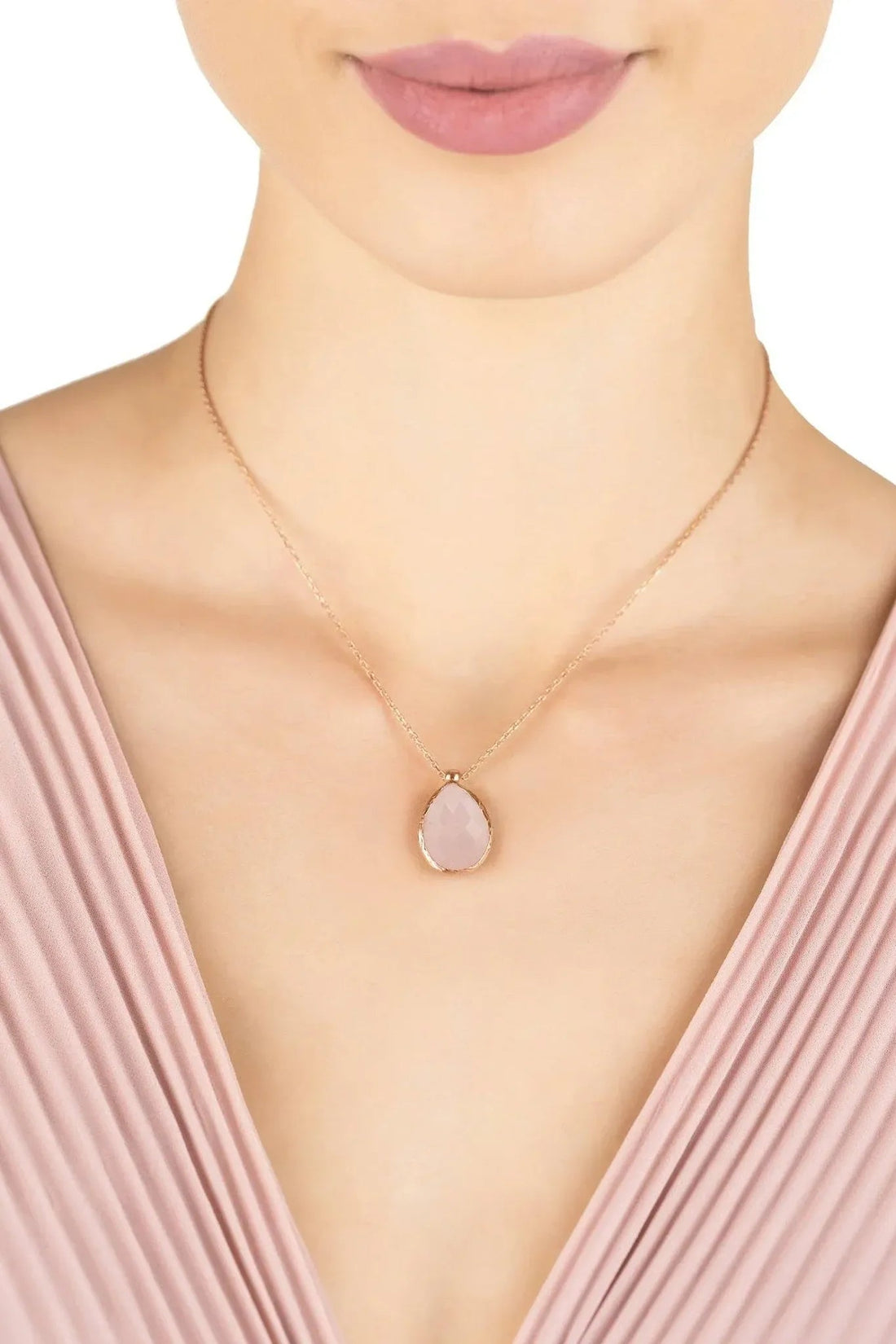 Rose gold rose quartz teardrop pendant necklace worn on model