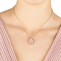 Rose gold rose quartz teardrop pendant necklace worn on model