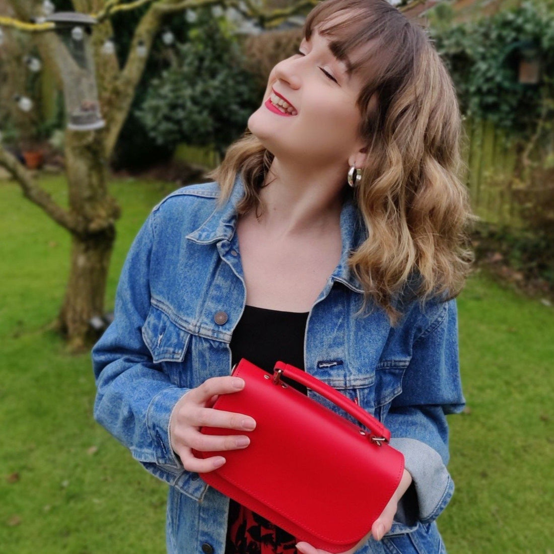 Red leather mini crossbody bag with top handle and front flap