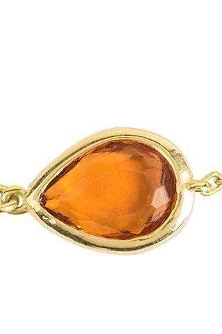 Close-up of gold mini teardrop bracelet clasp and amber stone