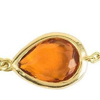 Close-up of gold mini teardrop bracelet clasp and amber stone