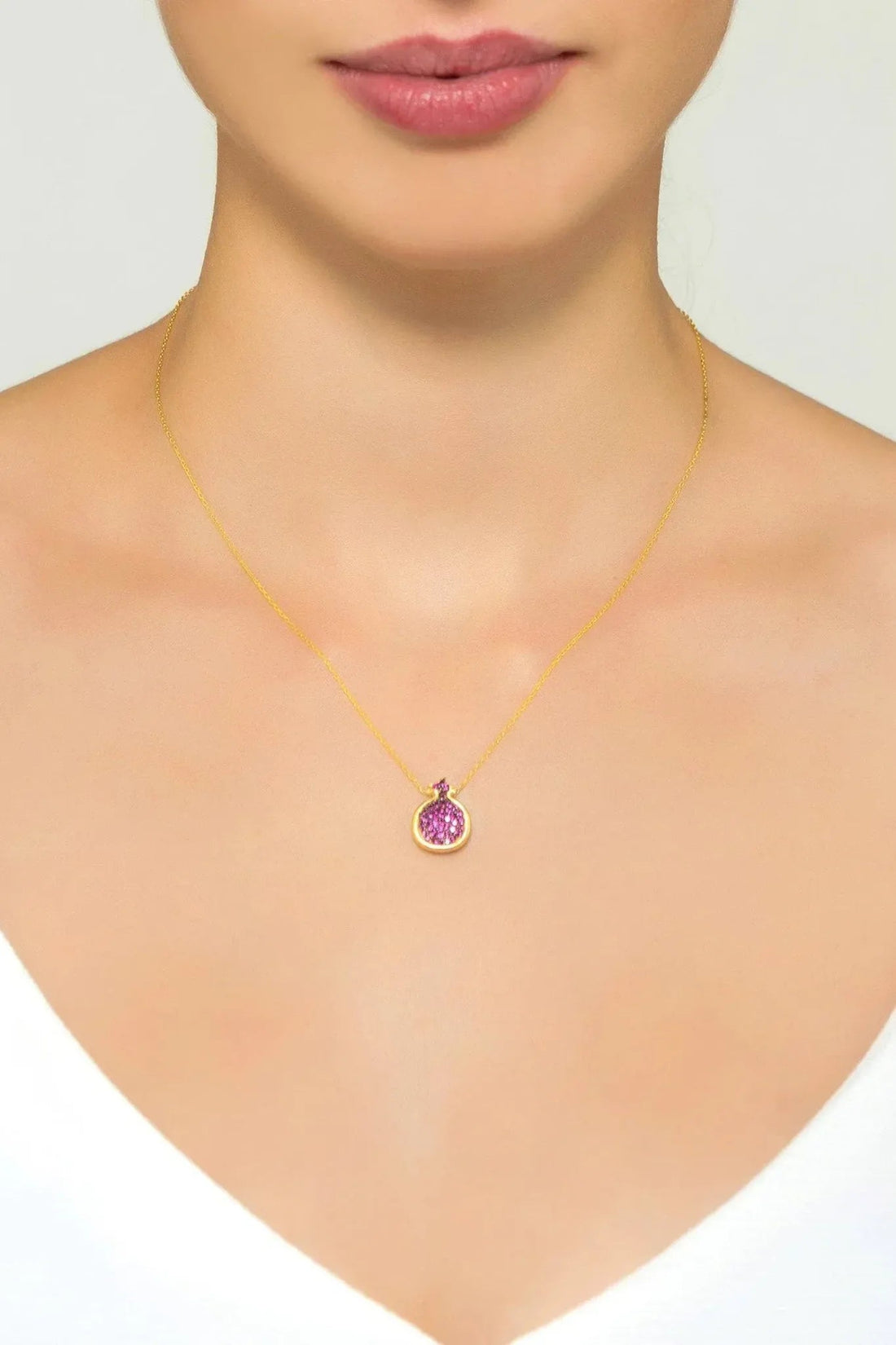 Gold necklace with ruby-pink crystal-set pomegranate pendant on a fine chain