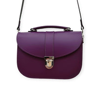 Purple leather crossbody bag with flap closure and adjustable shoulder strap
