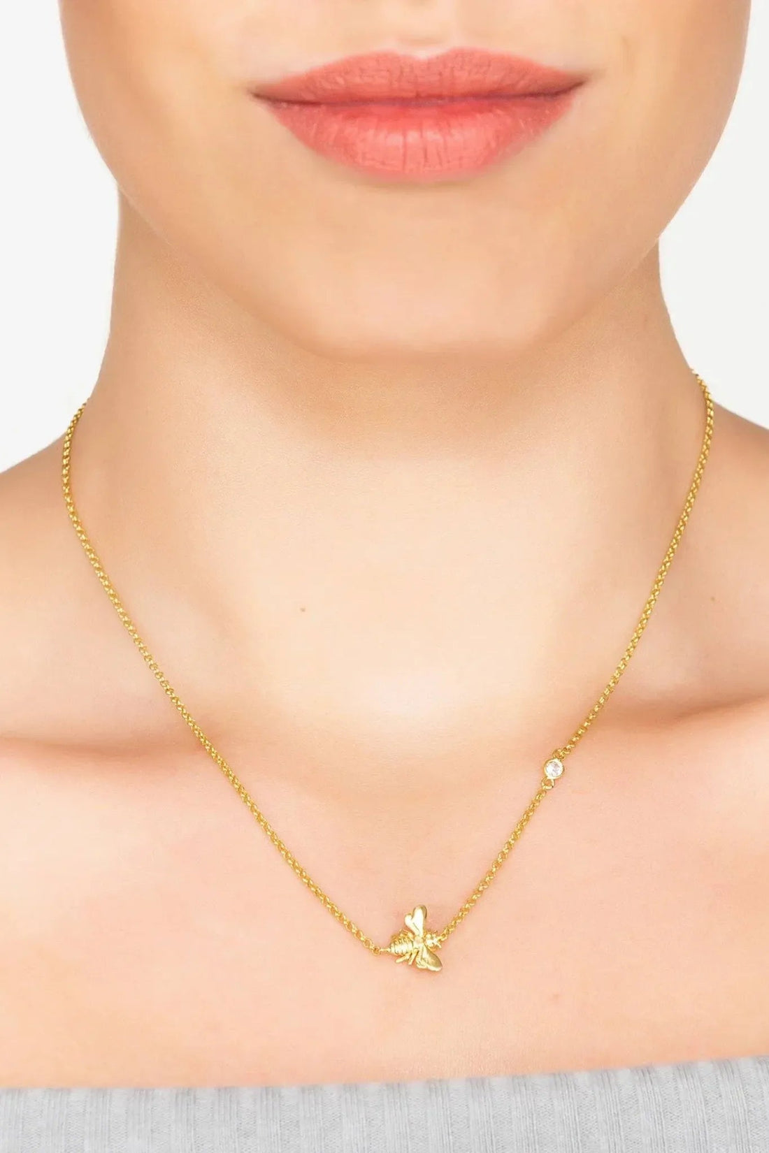 Gold-tone bee pendant necklace on model&