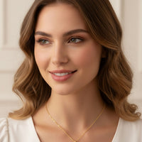 Gold zodiac talisman necklace worn on model, round pendant with blue birthstone