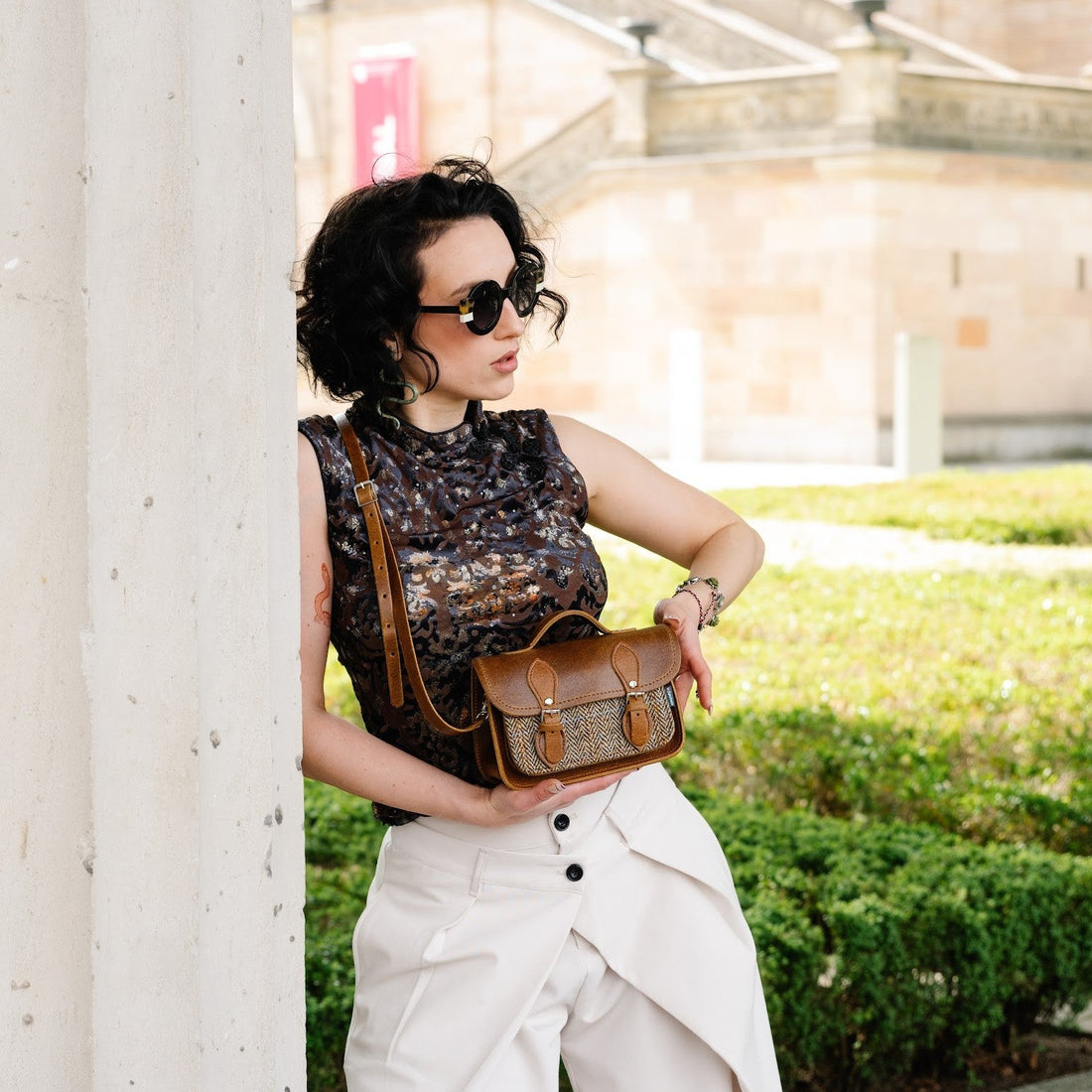 Tan leather and tweed micro satchel with flap and crossbody strap, side view