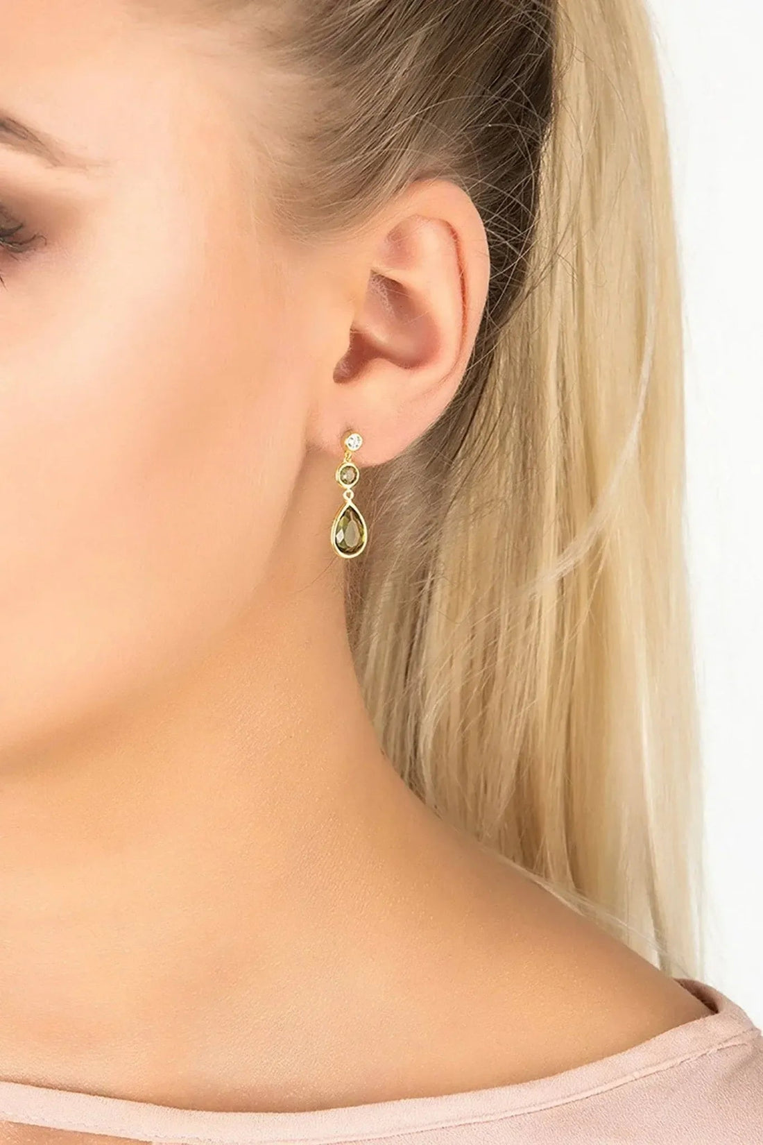 Gold-tone drop earrings with green teardrop gemstones and small round stones