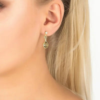 Gold-tone drop earrings with green teardrop gemstones and small round stones