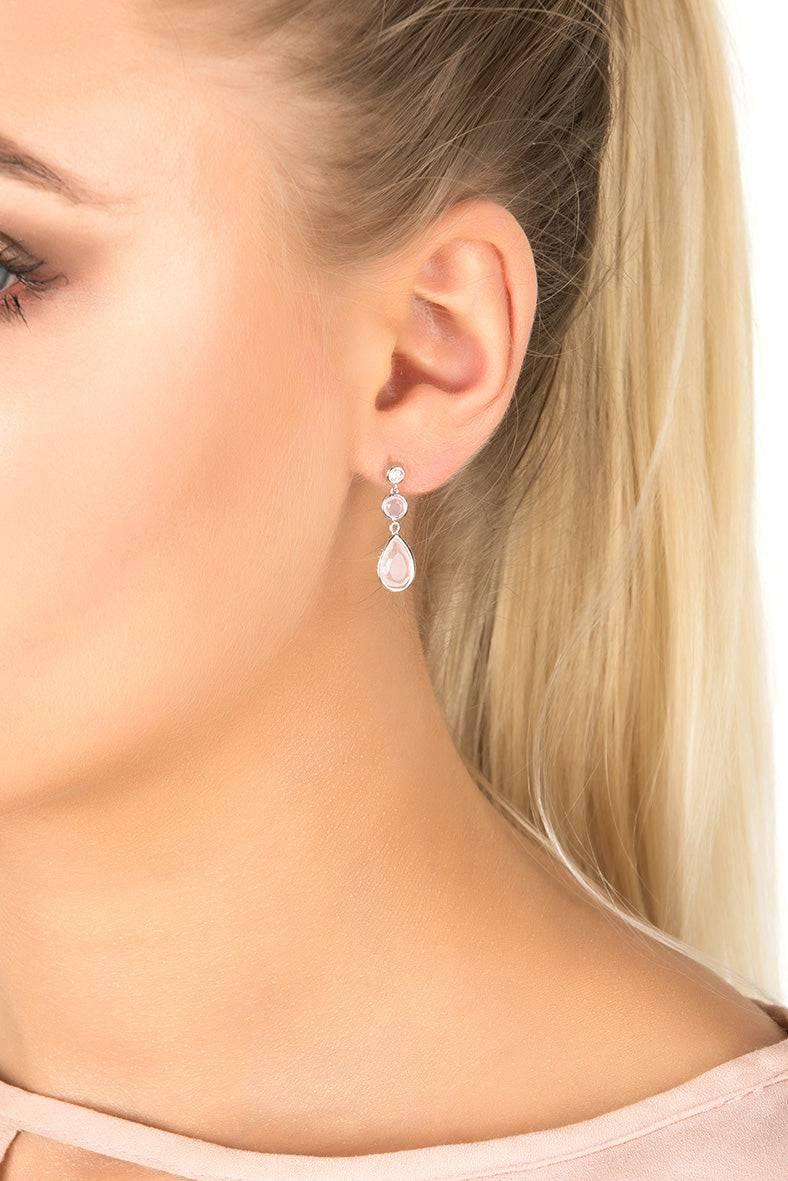 Rose quartz drop earrings on ear with small round top and silver hook