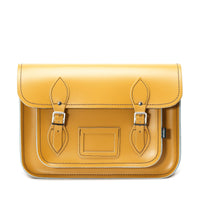 Yellow ochre leather satchel with flap closure, front pocket, and two buckle straps