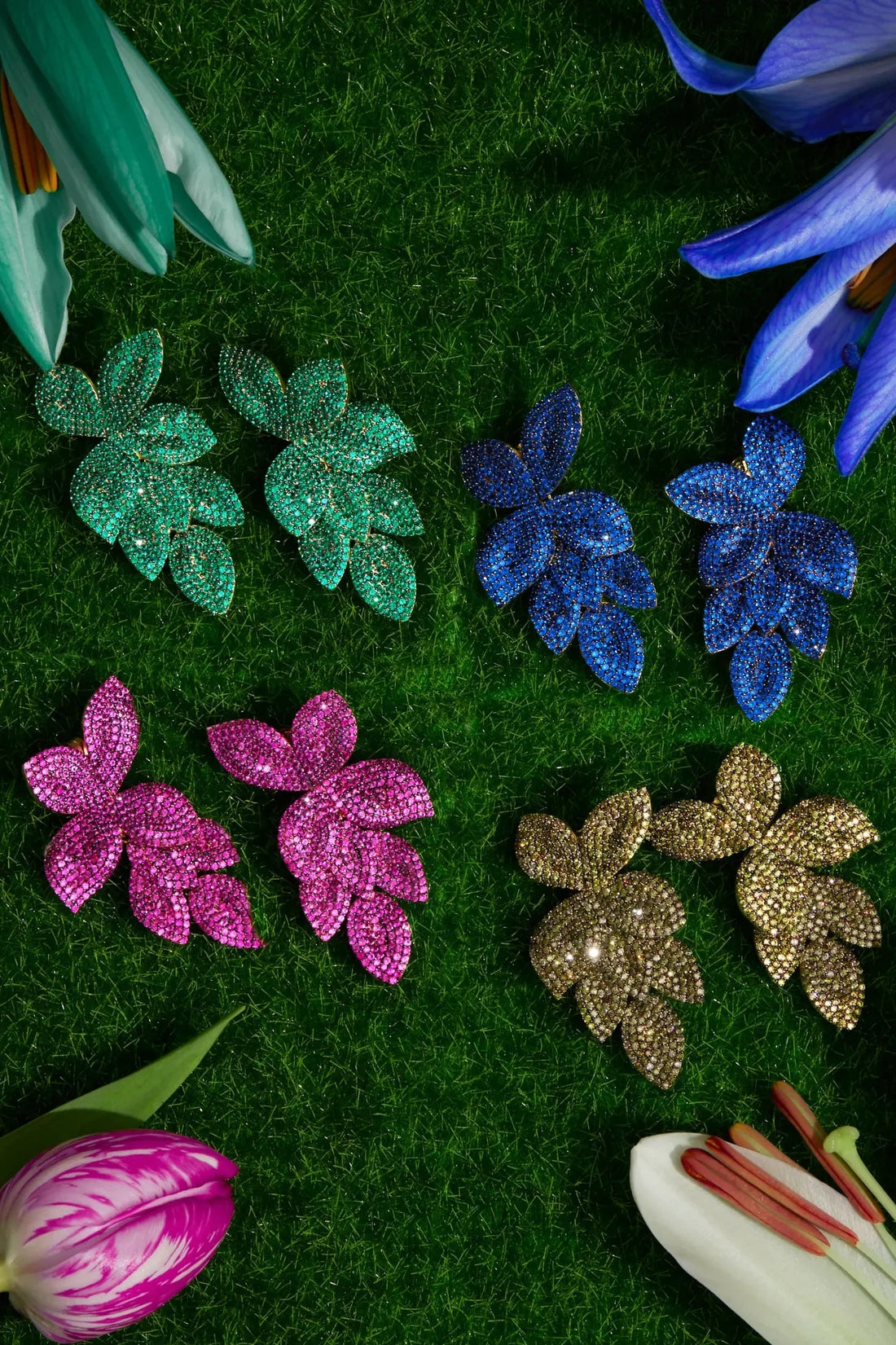 Emerald green rhinestone flower earrings displayed with other colors