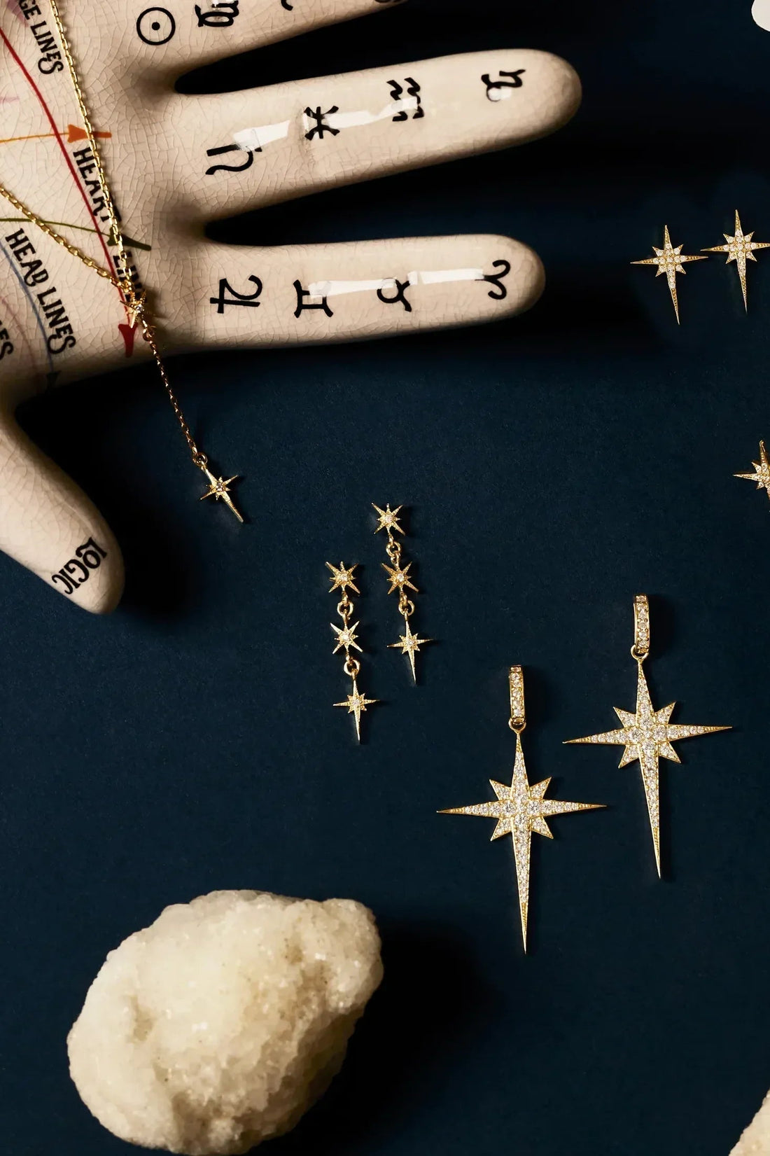 Set of gold starburst drop earrings with dangling crystal stars