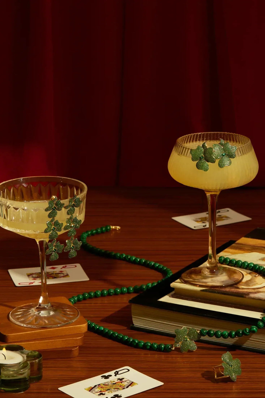 Triple drop green flower earrings on display stand, gold-tone hooks