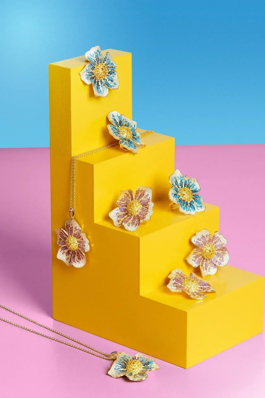 Gold-tone crystal flower earrings with blue and yellow centers