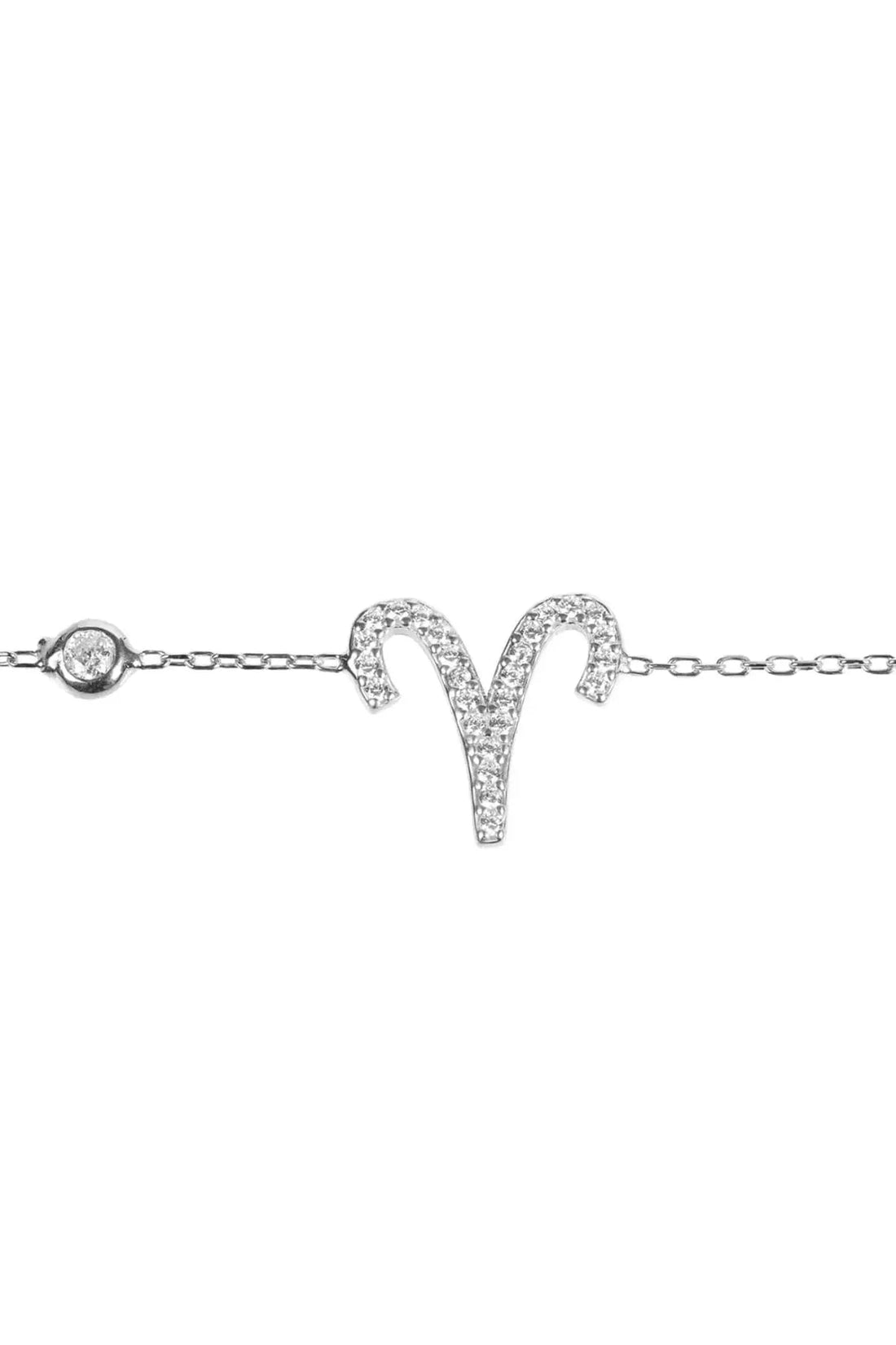 Aries zodiac bracelet close-up with round clasp charm and sparkling aries symbol, silver