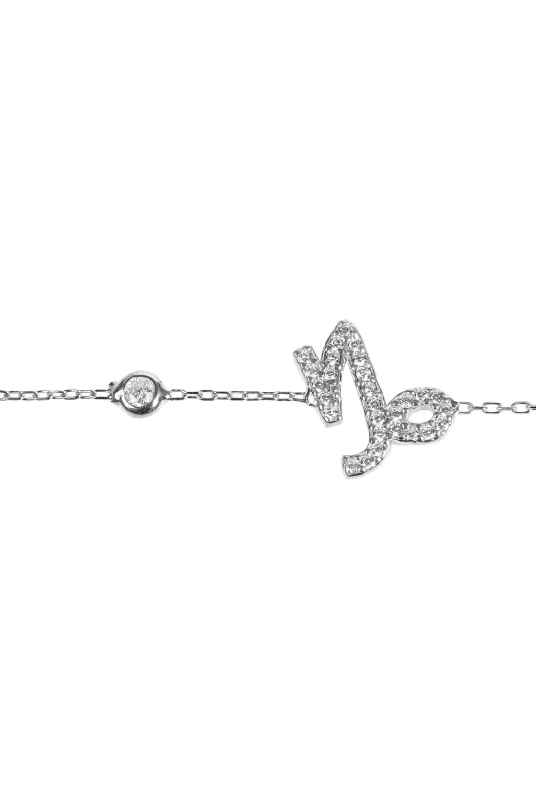 Silver Capricorn charm bracelet close-up with round link and glitter symbol