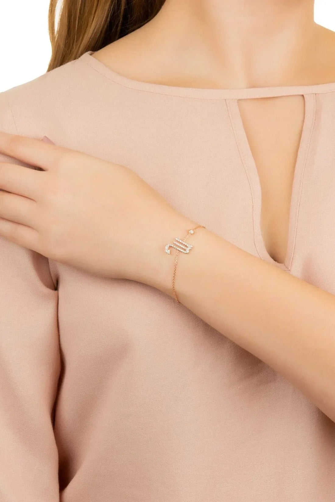 Rose-gold tone Scorpio star sign bracelet with rhinestone scorpion charm detail