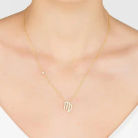 Gold zodiac pendant necklace with small Virgo symbol on chain