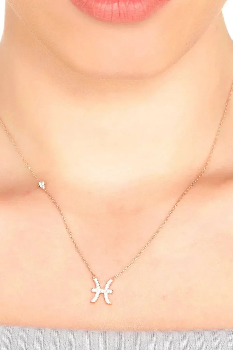 Zodiac Pisces pendant necklace with small starfish-style charm, delicate chain