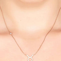 Silver-tone Taurus zodiac pendant necklace with small ring pendant on fine chain